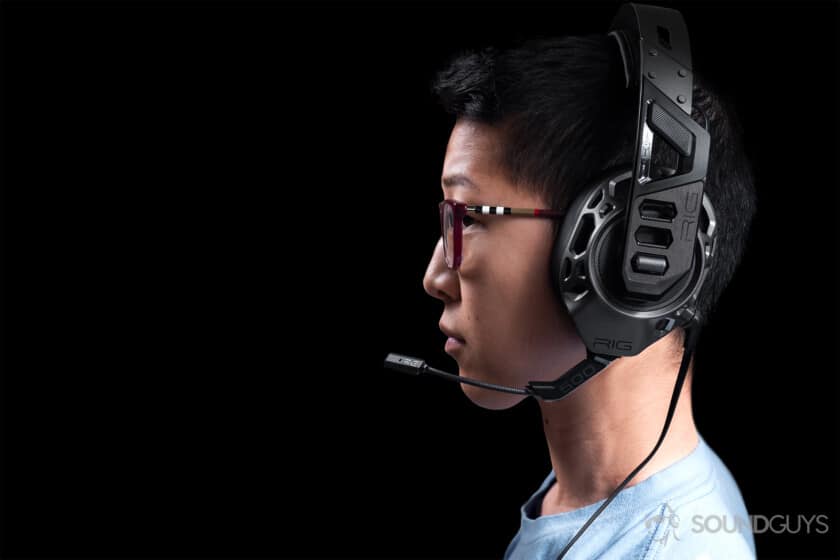 A woman wearing the Plantronics Rig Pro Gaming headset against a black background.