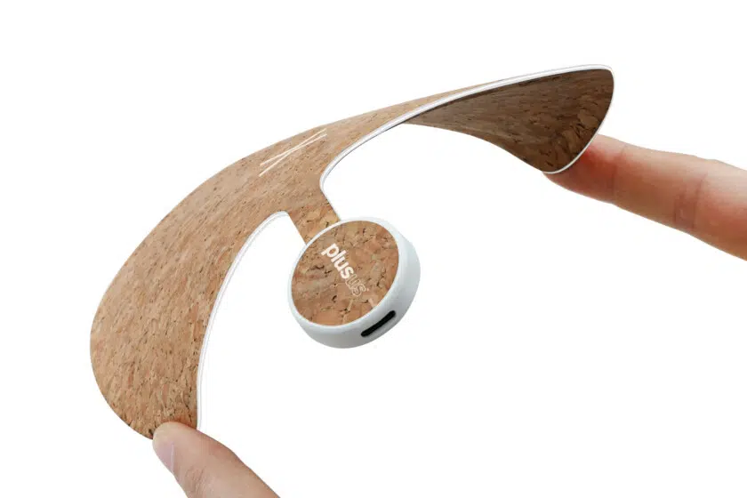 A promotional photo of the Plusus Xpad Wireless Charger being squeezed to emphasize its flexibility.