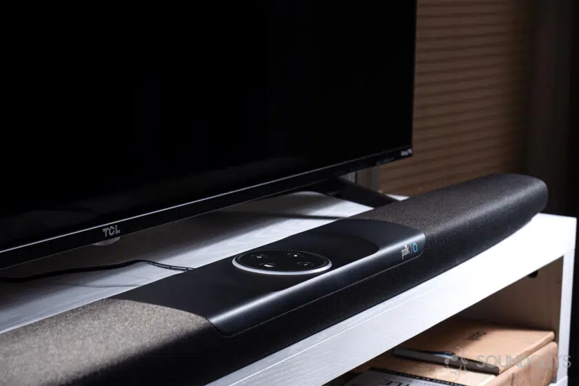 Polk Command Bar Alexa speaker on a white TV stand with a TCL TV.