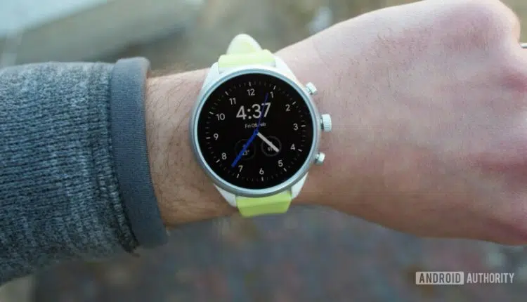 Photo of smartwatch Fossil Sport on a hand with turned on oled display watch face