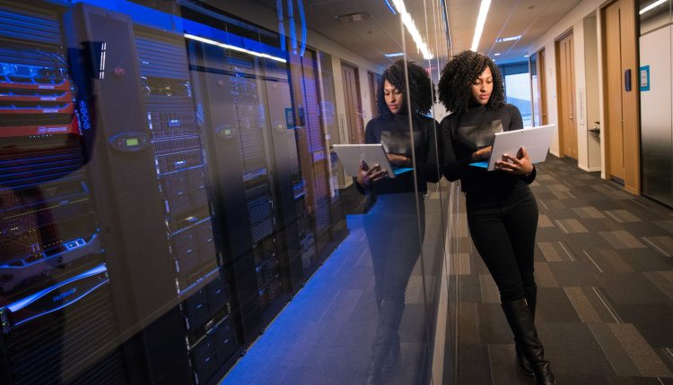 woman in black top using Surface laptop