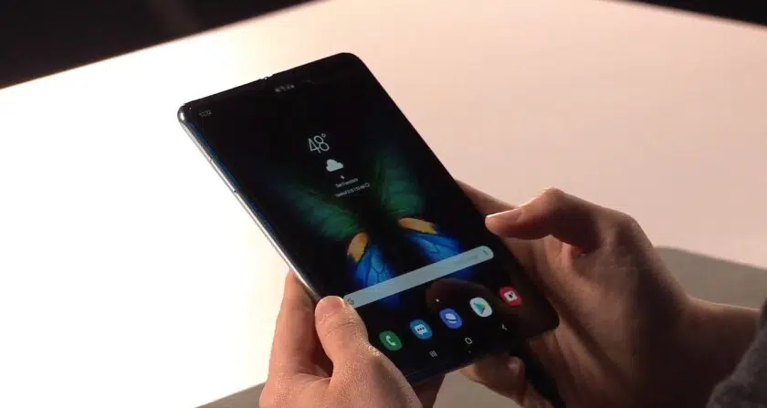 Front side photo of the Samsung galaxy fold in a tablet mode, held in a hand.