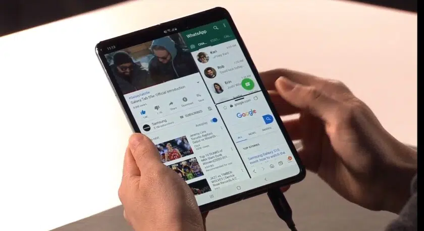 front side photo of the Samsung galaxy fold in a tablet mode, held in a hand.
